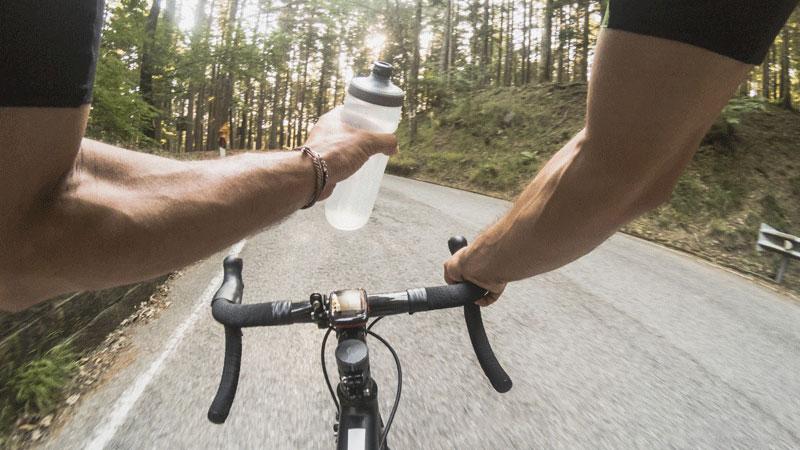 cyclist view drinking from water bottle